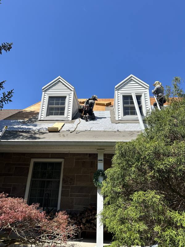 Crew working on stone home dormers — NJ